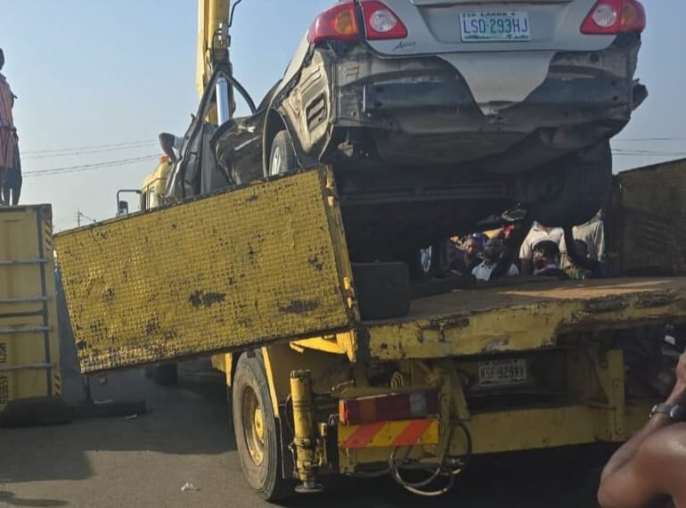 Lagos driver survives as large container falls on his vehicle