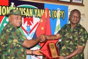 Theatre Commander of Operation Fansan Yamma (OPFY), Major General Oluyinka Soyele (right) presenting a souvenir to Group Captain Ibrahim Bukar, who led Defence Correspondents from the Defence Headquarters Abuja on the media tour.