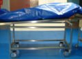 Covered body on mortuary trolley after pastor death