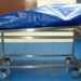 Covered body on mortuary trolley after pastor death