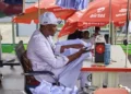 Abdulkadir Basari at his sewing machine during the 120-hour sewing marathon in Kano