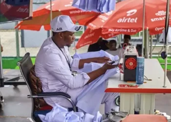 Abdulkadir Basari at his sewing machine during the 120-hour sewing marathon in Kano