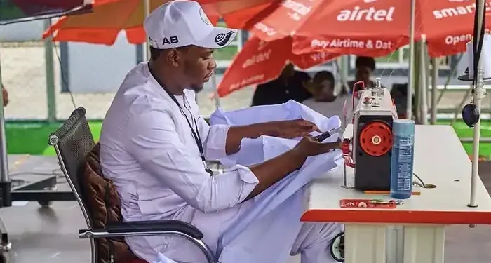 Abdulkadir Basari at his sewing machine during the 120-hour sewing marathon in Kano