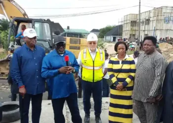 Gov. Sheriff Oborevwori speaking beside a Julius Berger representative at the failed section of the East-West Road in Agbarho
